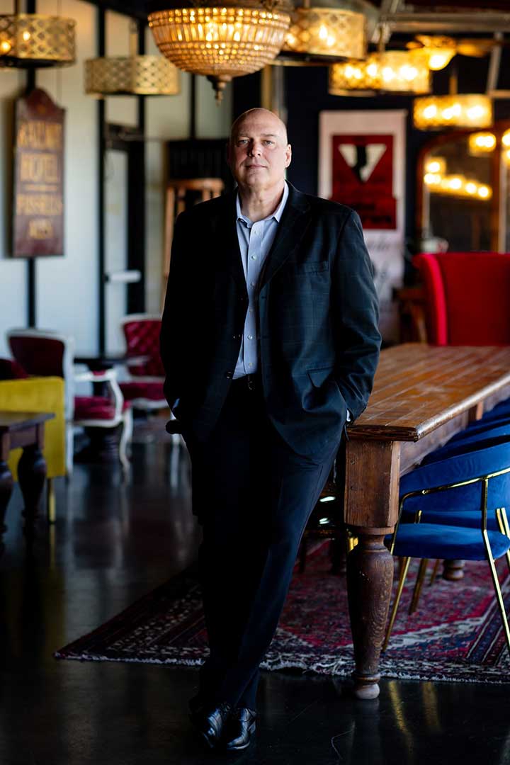 Photo of Patrick Kelly, 4th Season Consulting CEO and President standing against a conference table