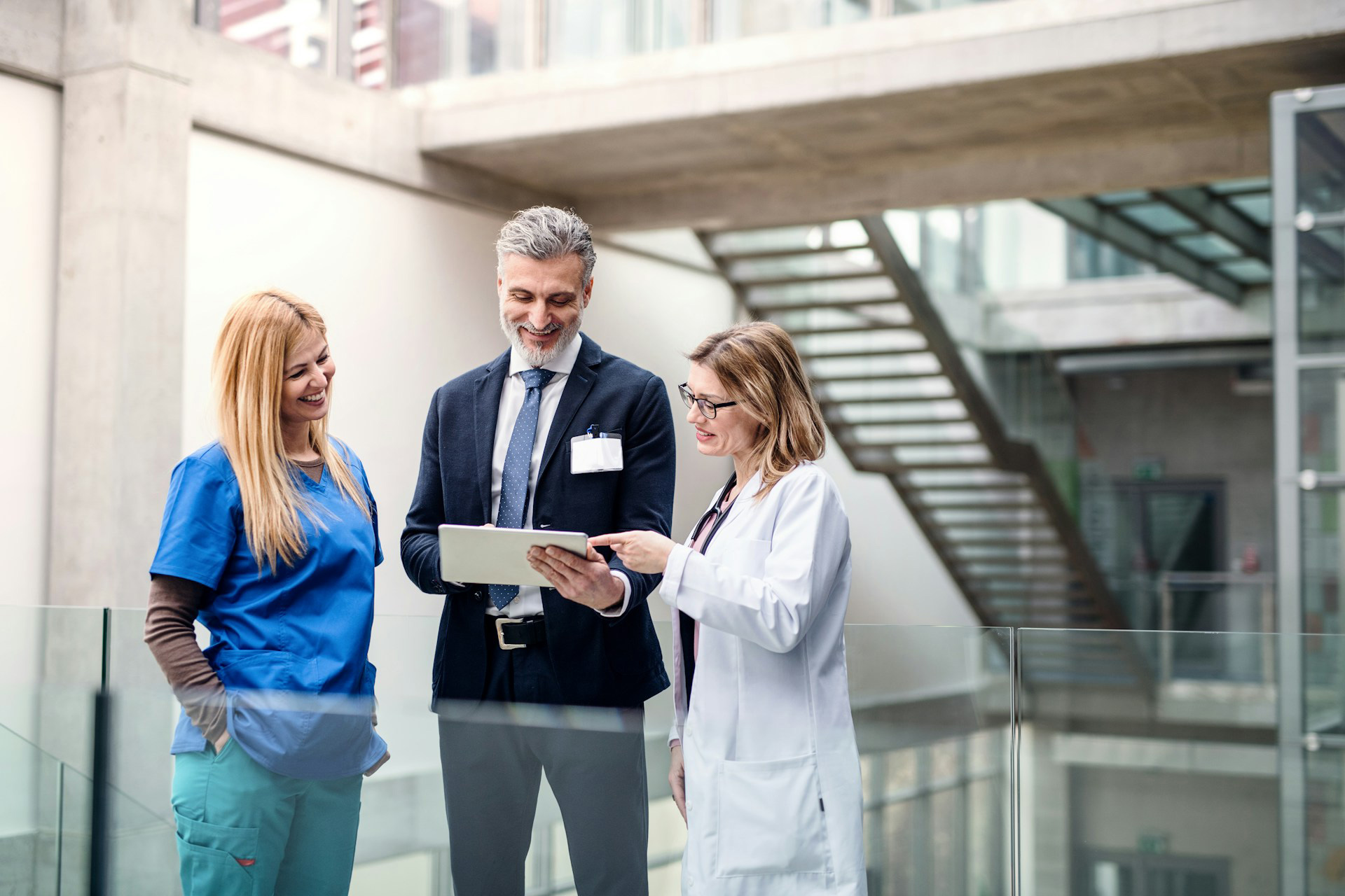 Male Healthcare CEO meeting with two female doctors in a practice's hallway