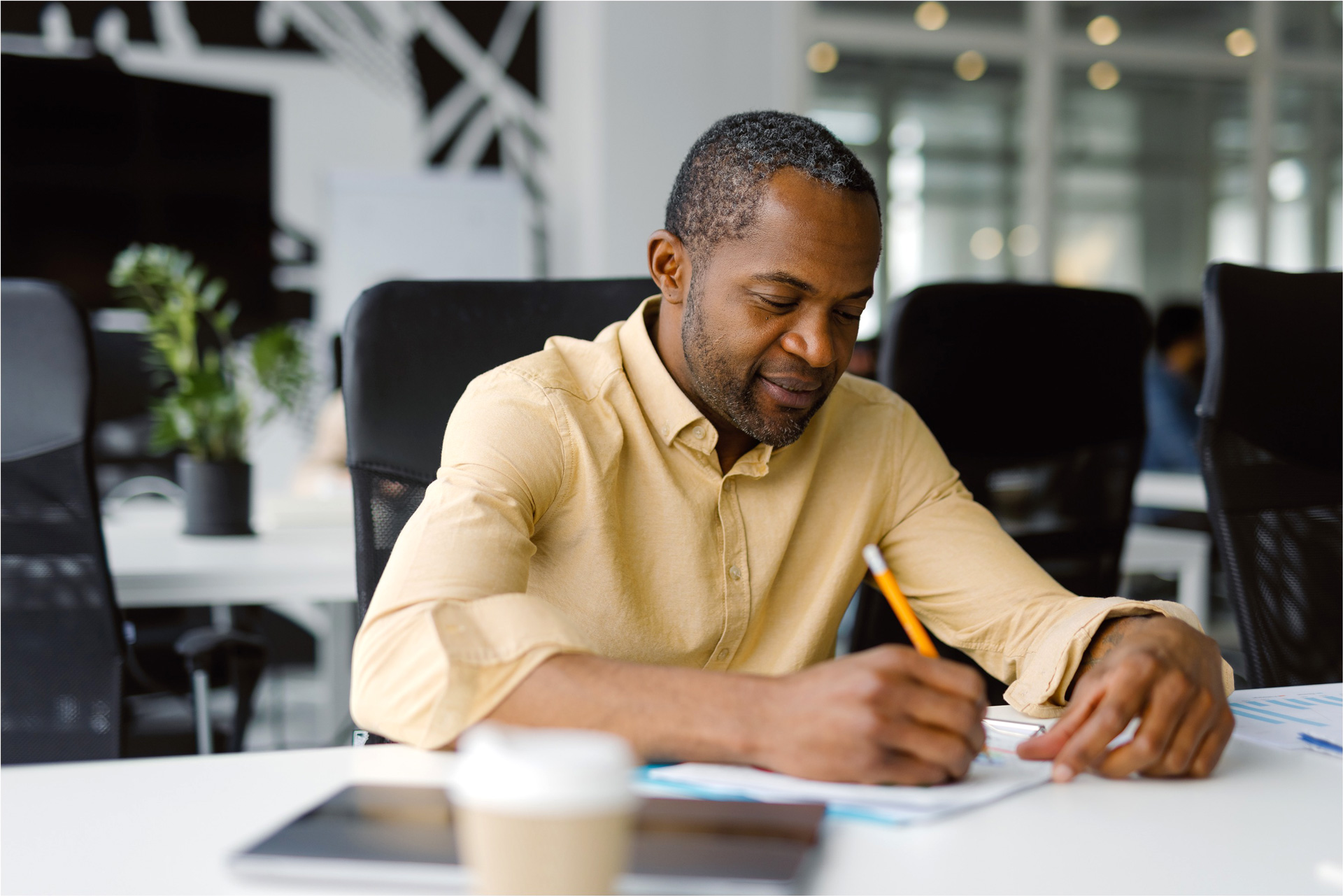 African American male is doing bookkeeping at his office for a healthcare practice